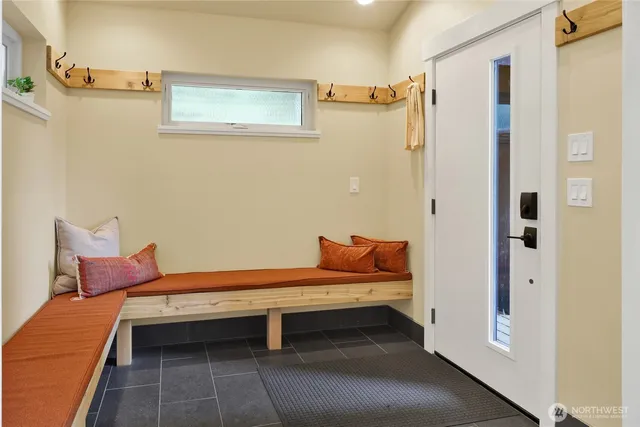 a reading room with wooden floor and furniture