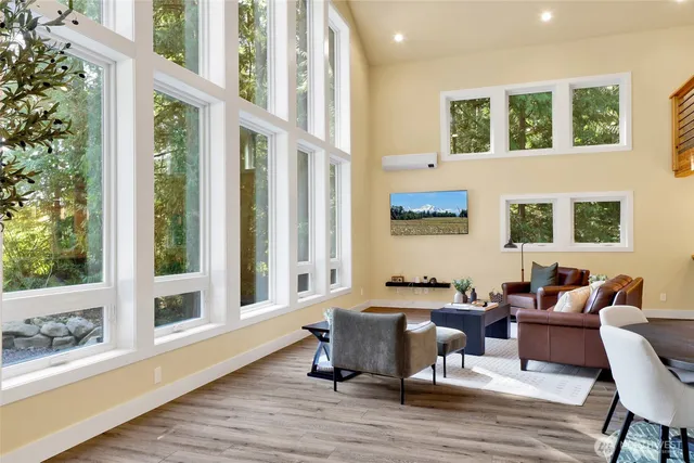 a living room with furniture and large windows