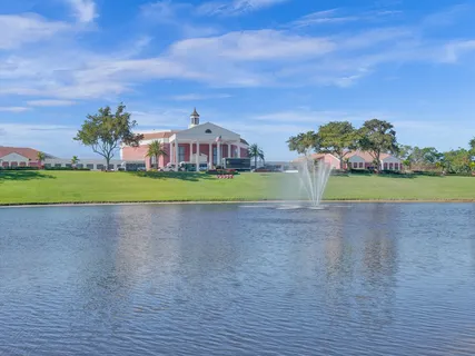 a view of a big house with a big yard and a large tree