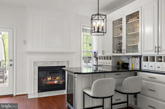 a kitchen with granite countertop a stove a sink and dishwasher with wooden floor