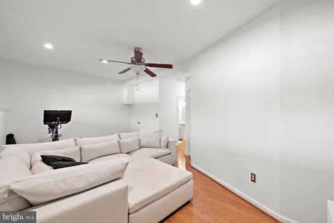 a living room with furniture and a ceiling fan