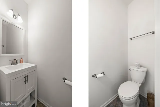 a bathroom with a toilet a sink and a mirror