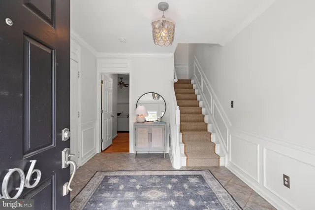 a view of a hallway with entryway wooden floor and front door