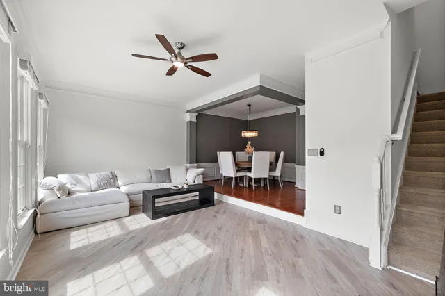 a living room with furniture and a chandelier