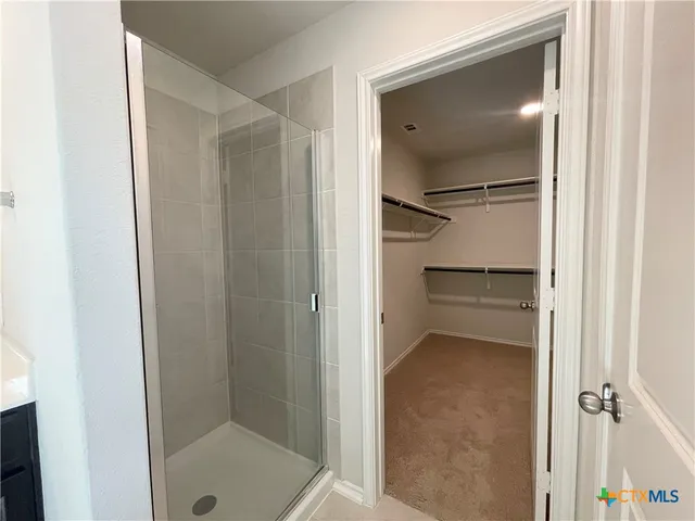 a bathroom with a glass shower door