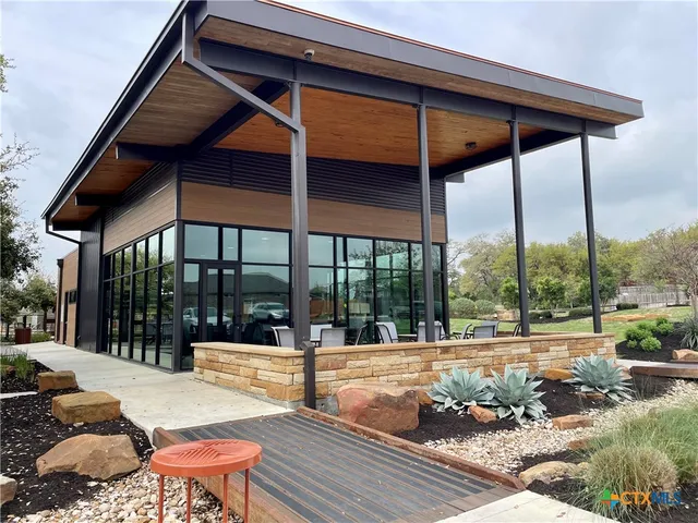a view of a swimming pool with outdoor seating