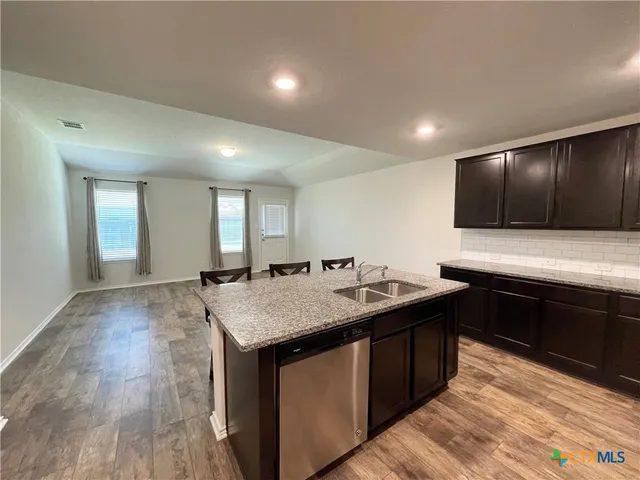 a kitchen with a stove a sink and a refrigerator