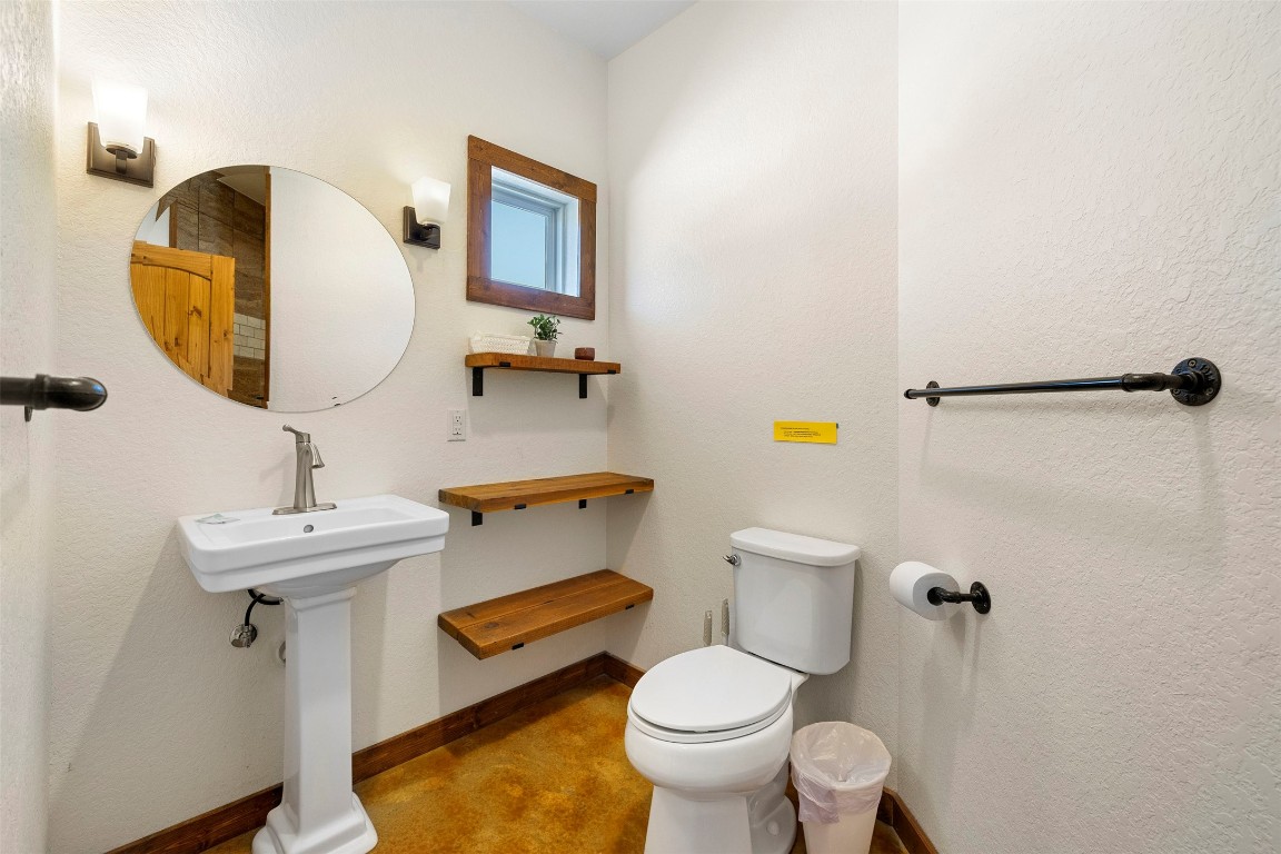 11 Stepping Stone Lane Concan, TX 78838 - Photo 19 of 47 a bathroom with a sink toilet and mirror