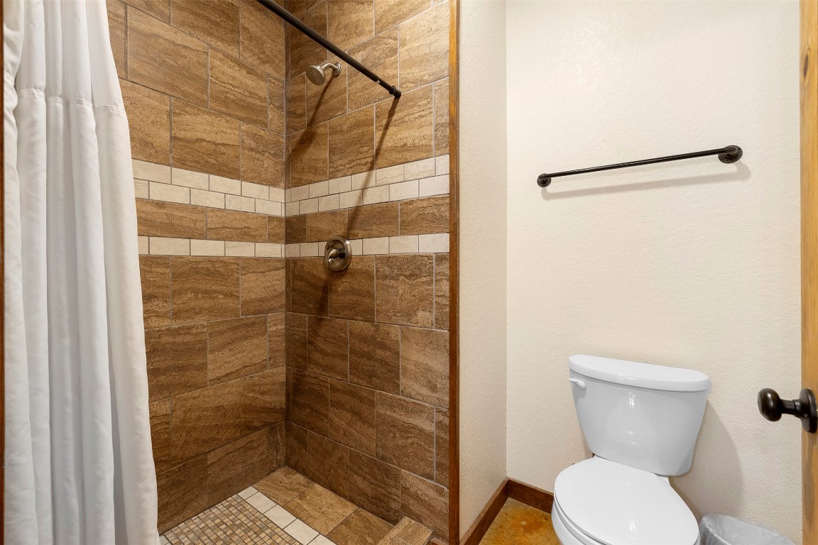 11 Stepping Stone Lane Concan, TX 78838 - Photo 26 of 47 a bathroom with a toilet and a shower
