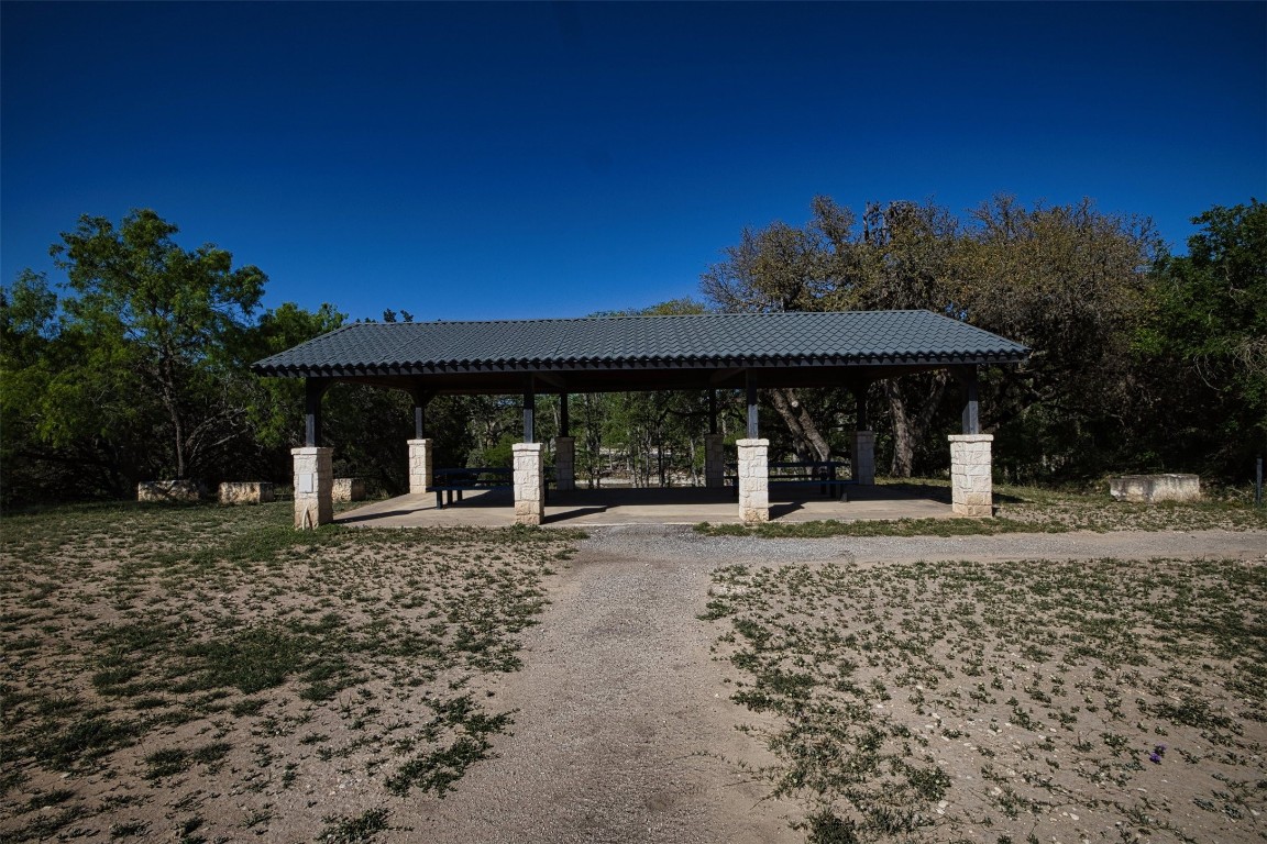 11 Stepping Stone Lane Concan, TX 78838 - Photo 42 of 47 a front view of a house with a garden