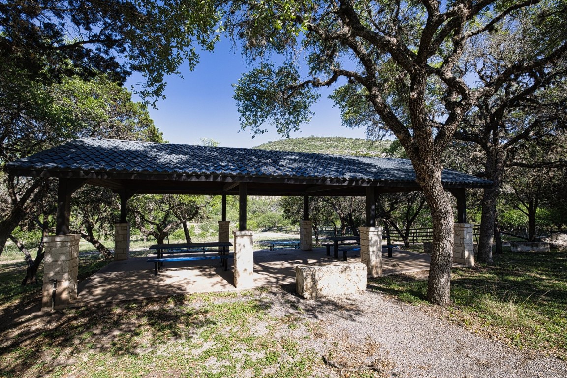 11 Stepping Stone Lane Concan, TX 78838 - Photo 47 of 47 a view of a patio with a table chairs and a floor to ceiling window