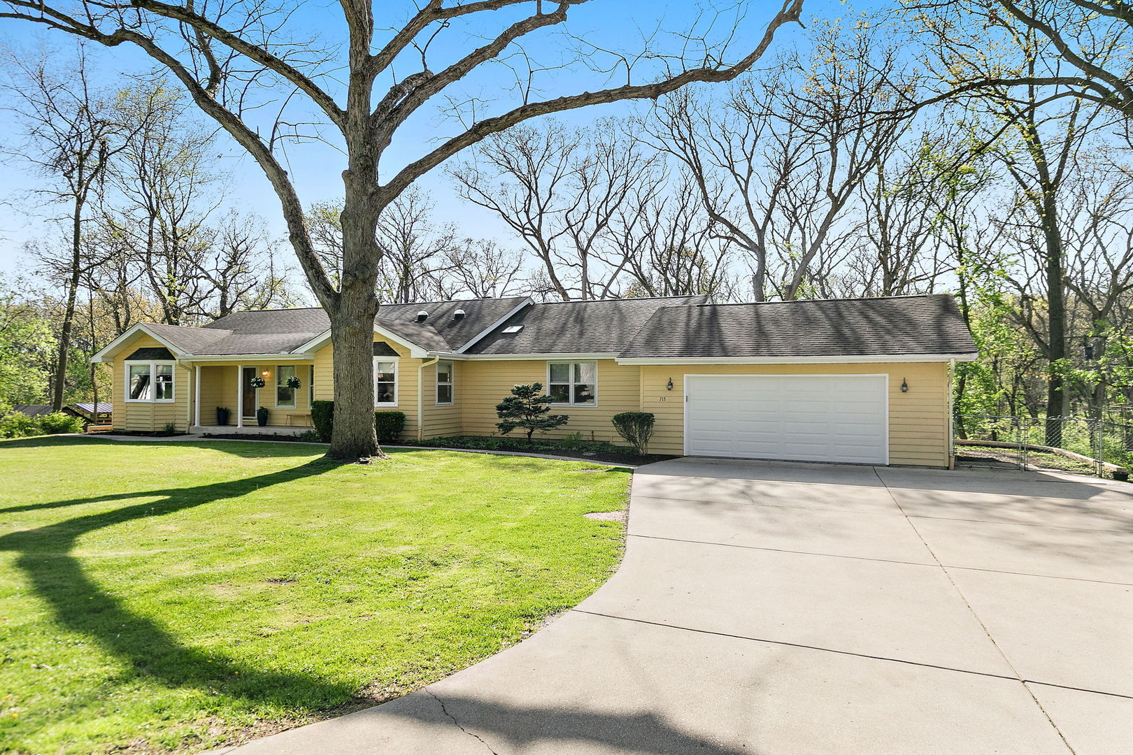 713 Council Hill Road East Dundee, IL 60118 - Photo 2 of 40 a yellow house with trees in front of it