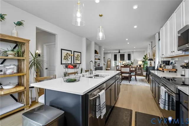 a open kitchen with stainless steel appliances kitchen island granite countertop a sink and cabinets