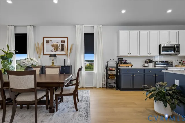 a kitchen with granite countertop a table and chairs in it