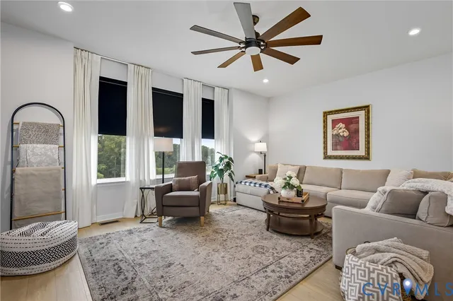 a living room with furniture and a large window
