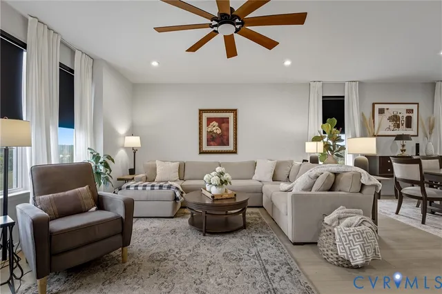 a living room with furniture and view of kitchen