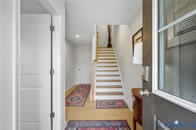 a view of entryway with furniture and stairs