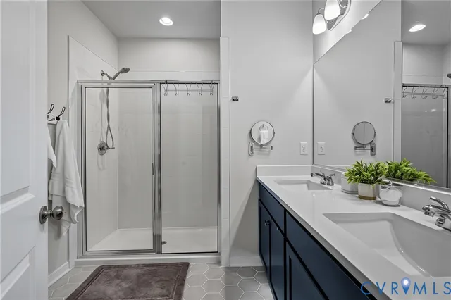 a bathroom with a double vanity sink toilet and a mirror