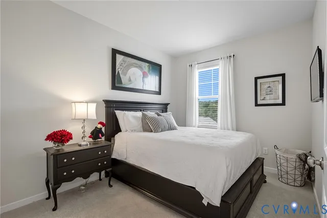 a bedroom with a bed and painting on the wall