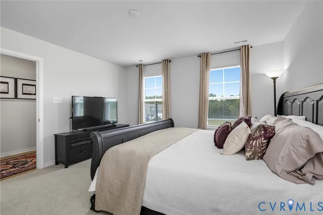 a bedroom with a bed and a large window