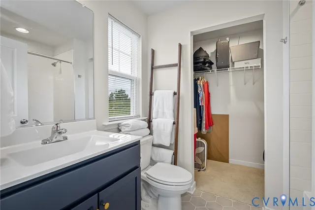 a bathroom with a bathtub sink and mirror