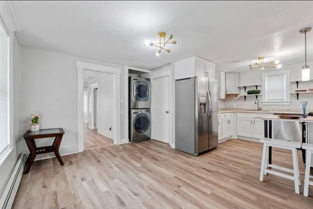 a kitchen with kitchen island white cabinets and stainless steel appliances
