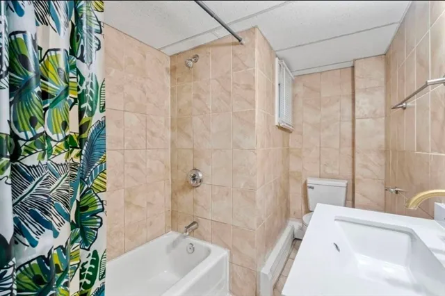 a bathroom with a sink a bathtub and shower