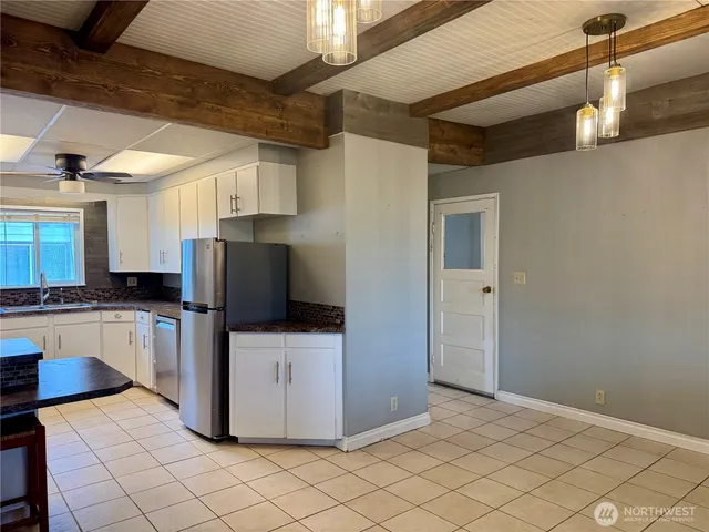 a kitchen with a refrigerator and a stove