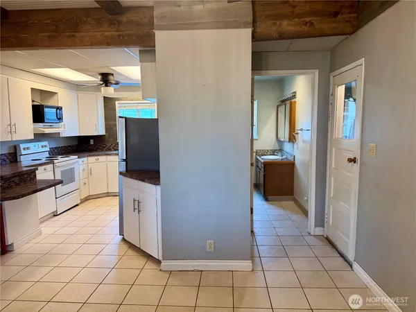a kitchen with stainless steel appliances a stove a sink and a refrigerator