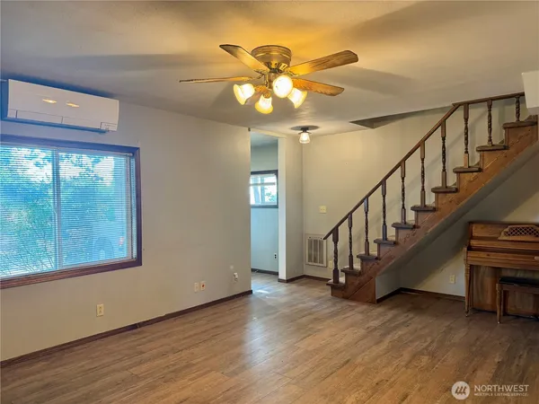 a view of an entryway and wooden floor