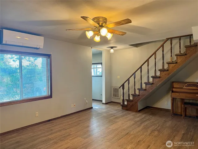 a view of an entryway and wooden floor