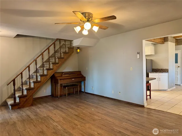 a view of entryway and hall with wooden floor