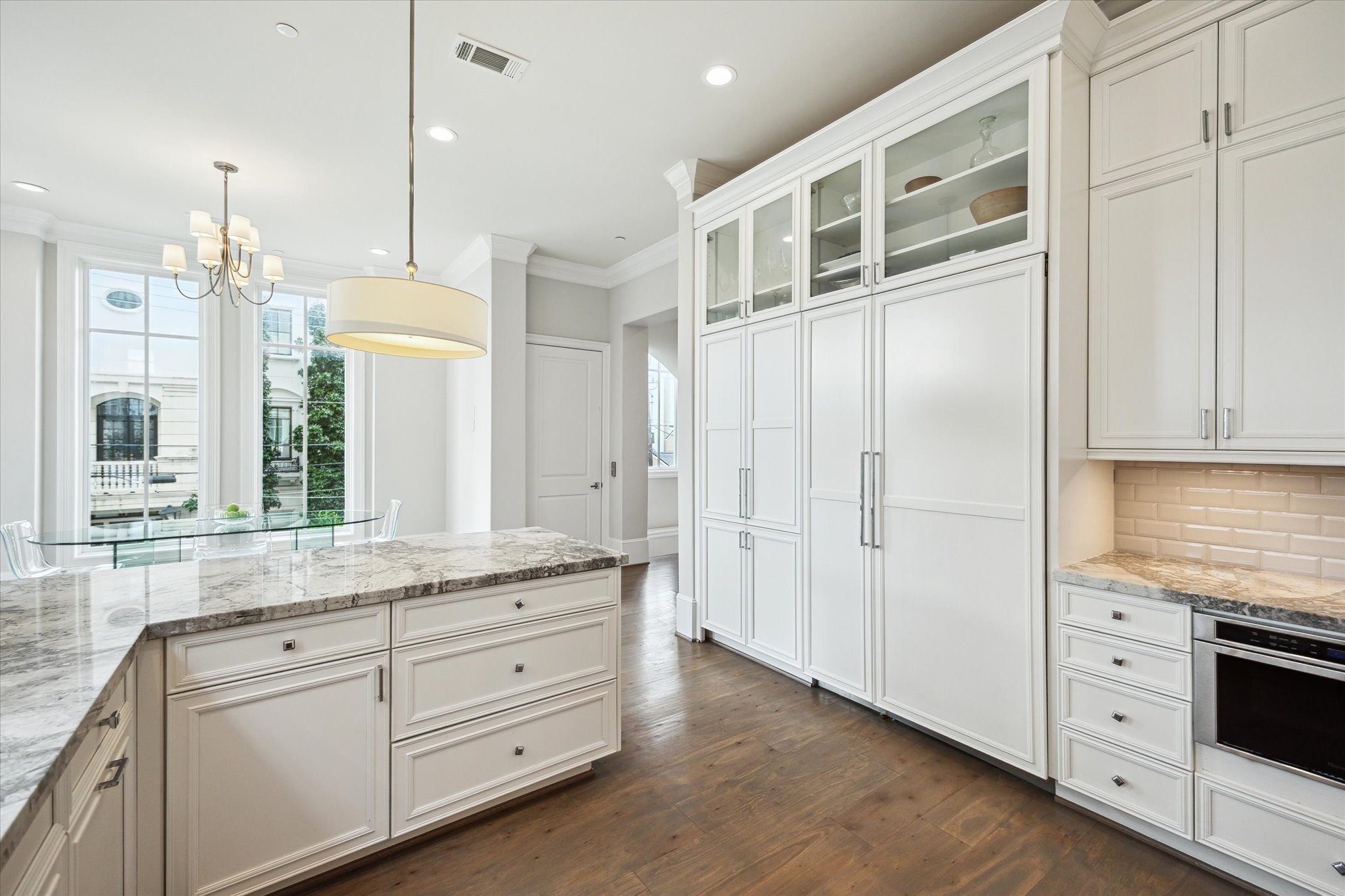 2336 Welch Street Houston, TX 77019 - Photo 21 of 39 a kitchen with granite countertop white cabinets and stainless steel appliances
