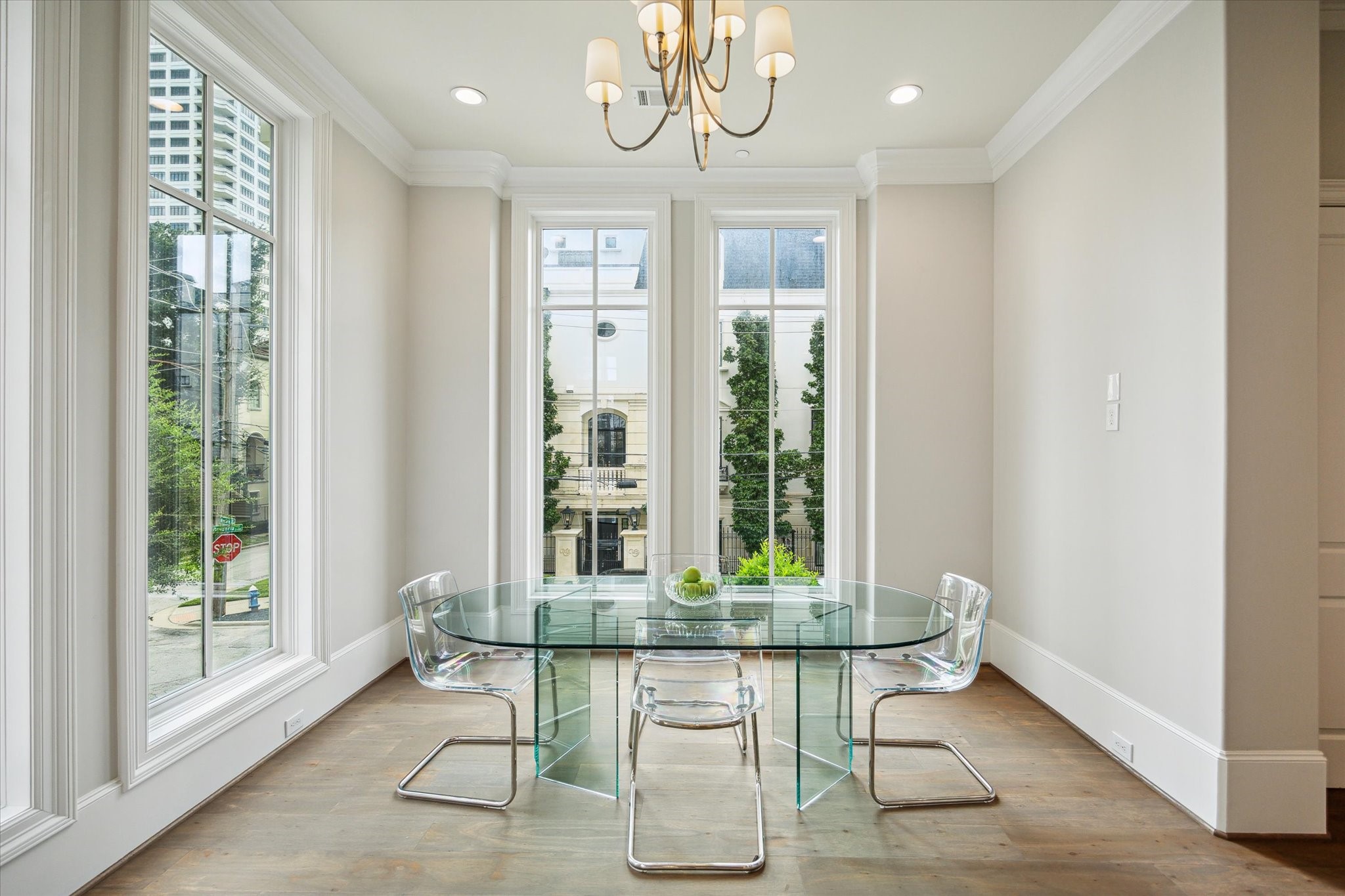 2336 Welch Street Houston, TX 77019 - Photo 22 of 39 a dining room with wooden floor and a chandelier