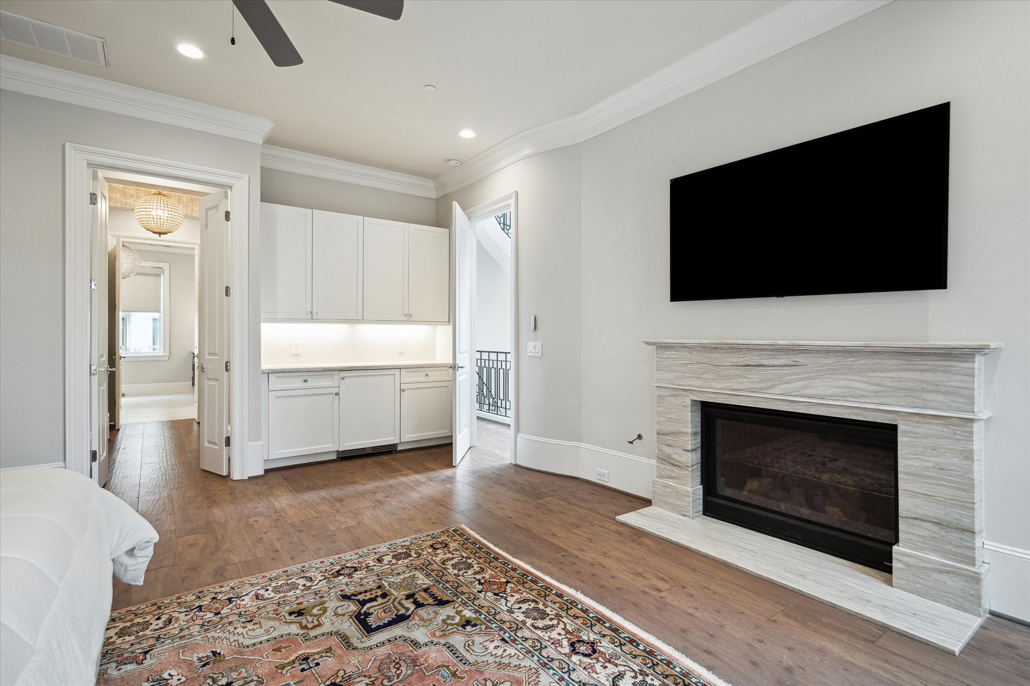 2336 Welch Street Houston, TX 77019 - Photo 27 of 39 a living room with a fireplace and a flat screen tv