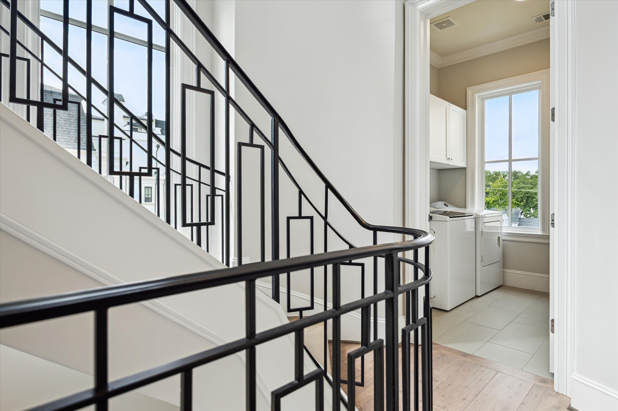 2336 Welch Street Houston, TX 77019 - Photo 32 of 39 a view of an entryway with wooden floor and stairs