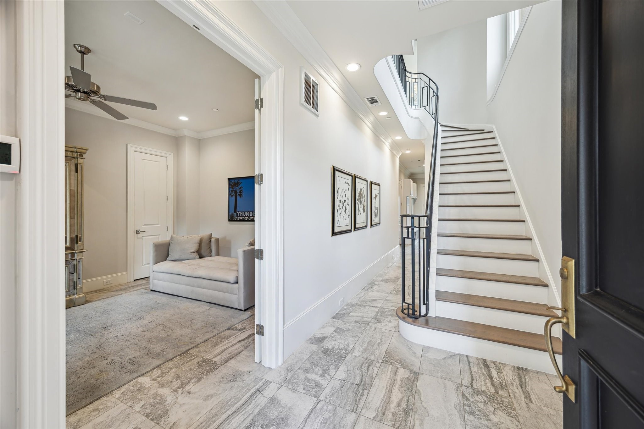 2336 Welch Street Houston, TX 77019 - Photo 7 of 39 a view of a bedroom with wooden floor and stairs