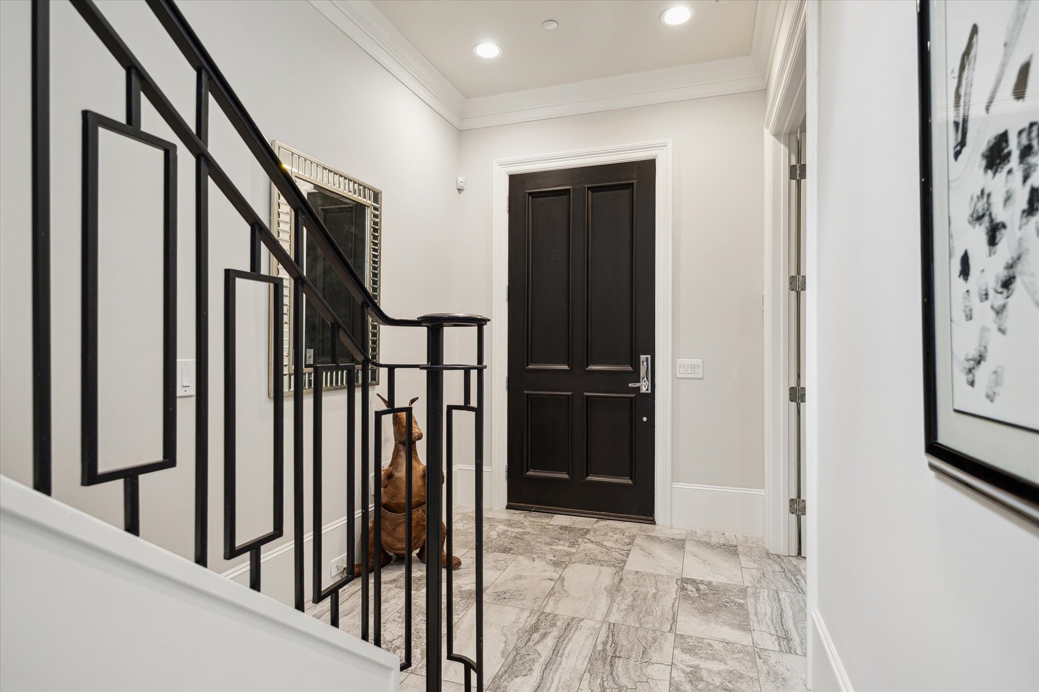 2336 Welch Street Houston, TX 77019 - Photo 8 of 39 a view of staircase with lots of frames on wall and a window