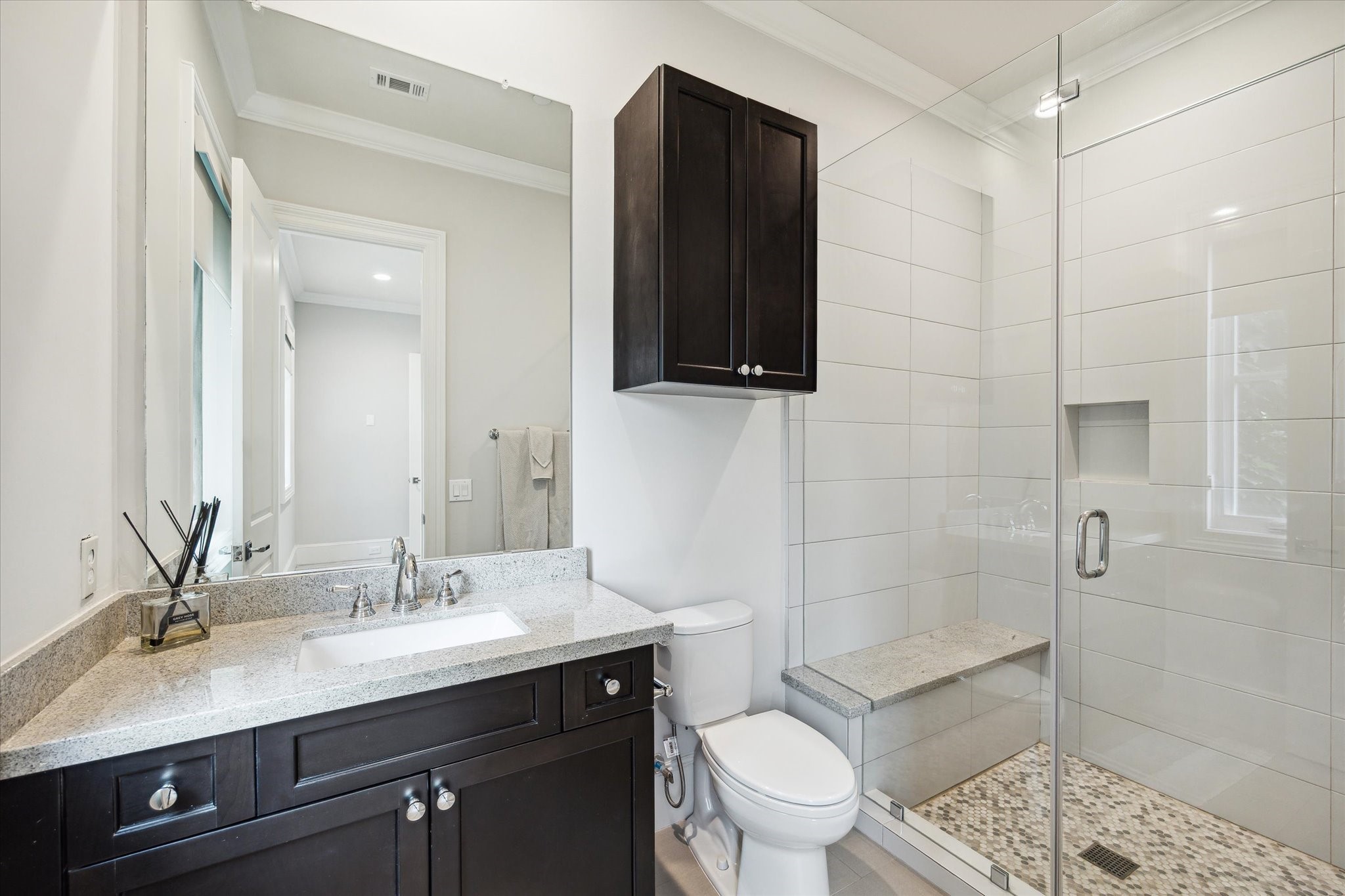 2336 Welch Street Houston, TX 77019 - Photo 10 of 39 a bathroom with a sink a toilet a mirror and shower