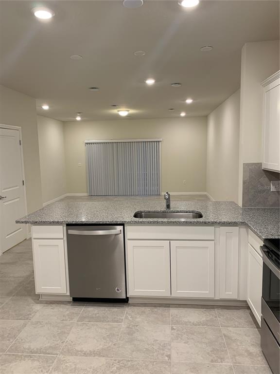 2563 Buena View Road Kissimmee, FL 34746 - Photo 3 of 15 a kitchen with stainless steel appliances granite countertop a sink and cabinets