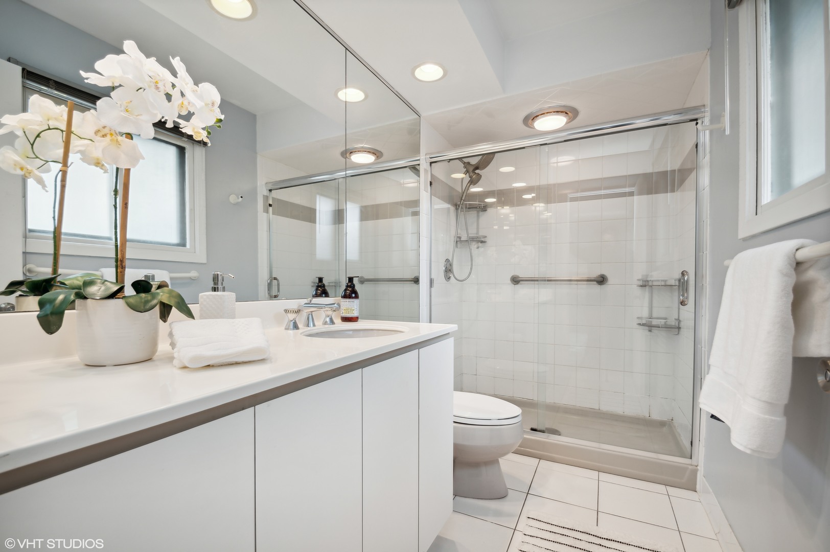 1734 Birch Road Northbrook, IL 60062 - Photo 13 of 27 a bathroom with a granite countertop sink a toilet a mirror and shower