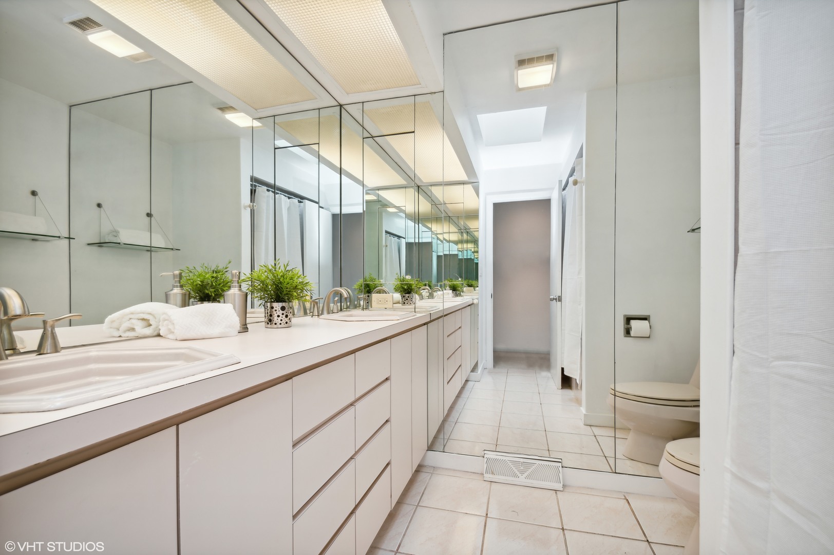 1734 Birch Road Northbrook, IL 60062 - Photo 17 of 27 a bathroom with a double vanity sink and a mirror