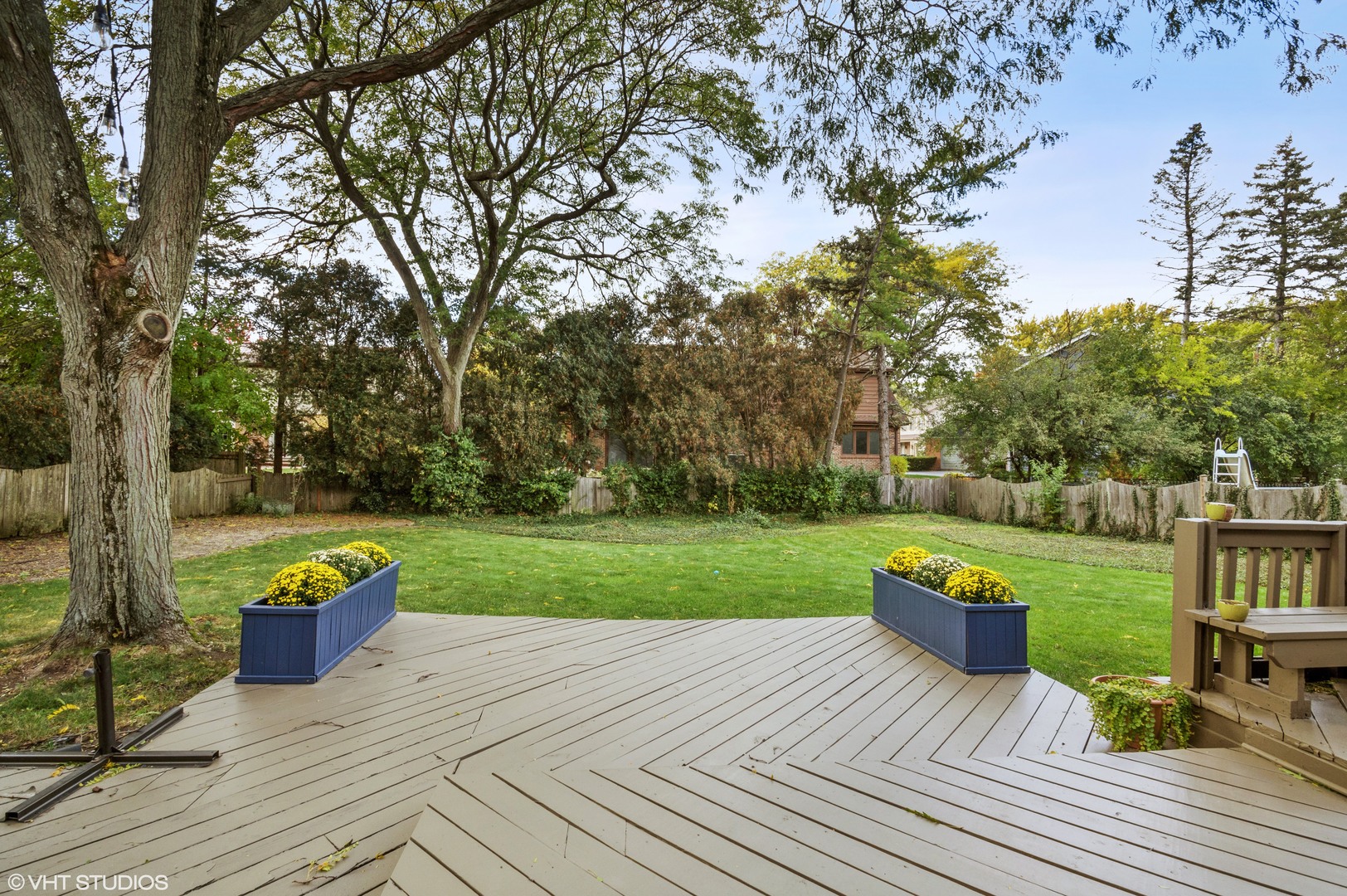 1734 Birch Road Northbrook, IL 60062 - Photo 22 of 27 a view of a deck with table and chairs and a fire pit