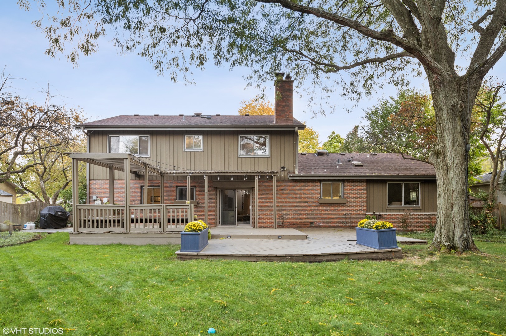 1734 Birch Road Northbrook, IL 60062 - Photo 23 of 27 a front view of a house with a garden and a tree