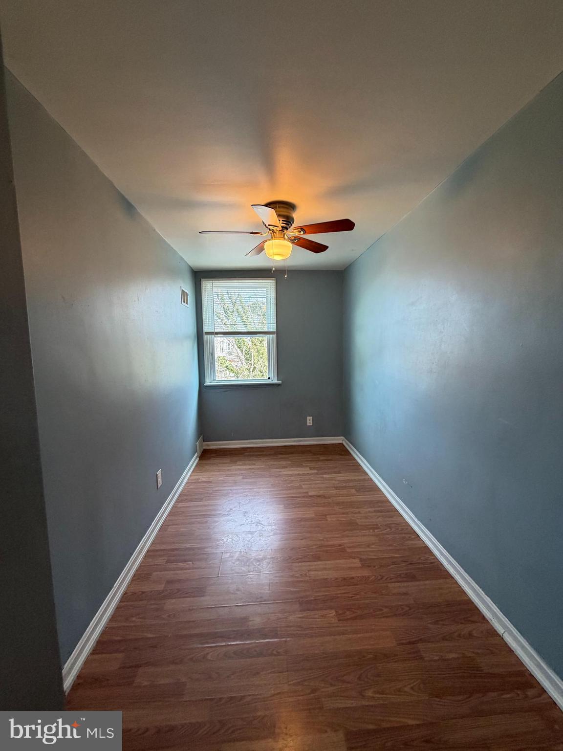 7 West 21st Street Chester, PA 19013 - Photo 13 of 18 an empty room with wooden floor and windows