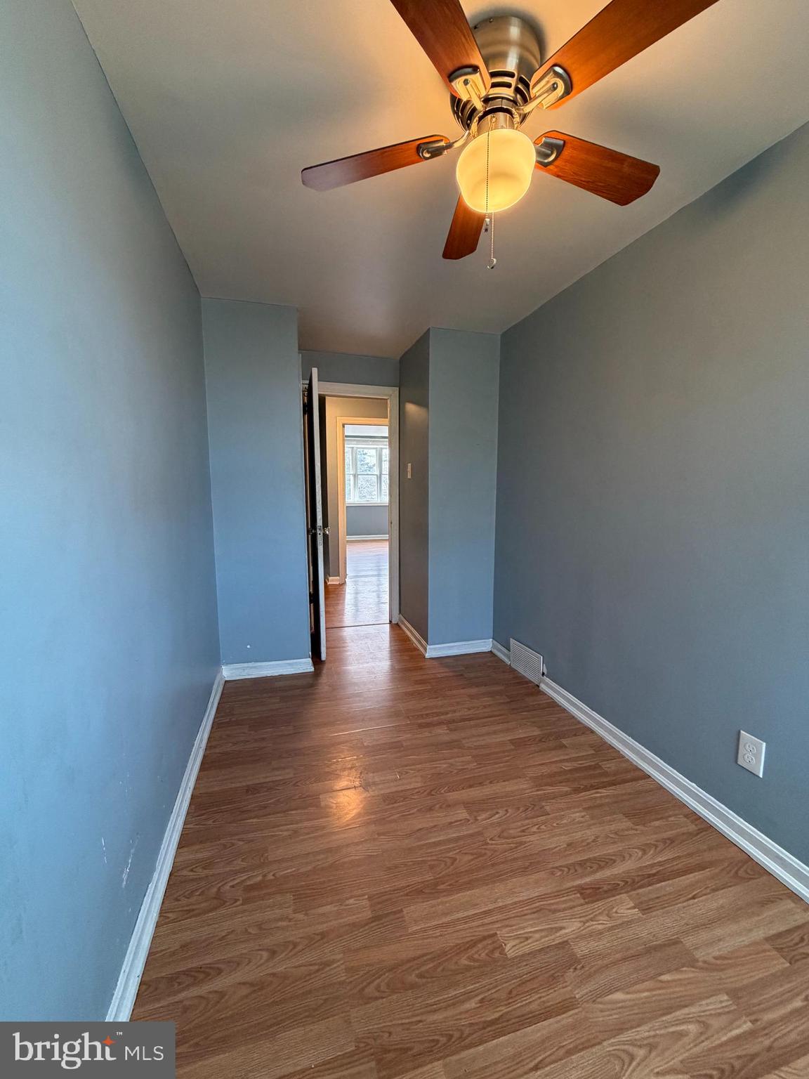 7 West 21st Street Chester, PA 19013 - Photo 14 of 18 a view of an empty room with window and wooden floor