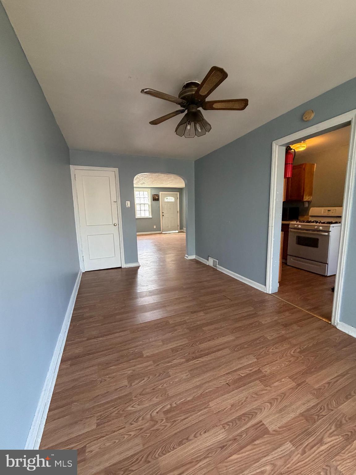 7 West 21st Street Chester, PA 19013 - Photo 5 of 18 a view of empty room with wooden floor and fan