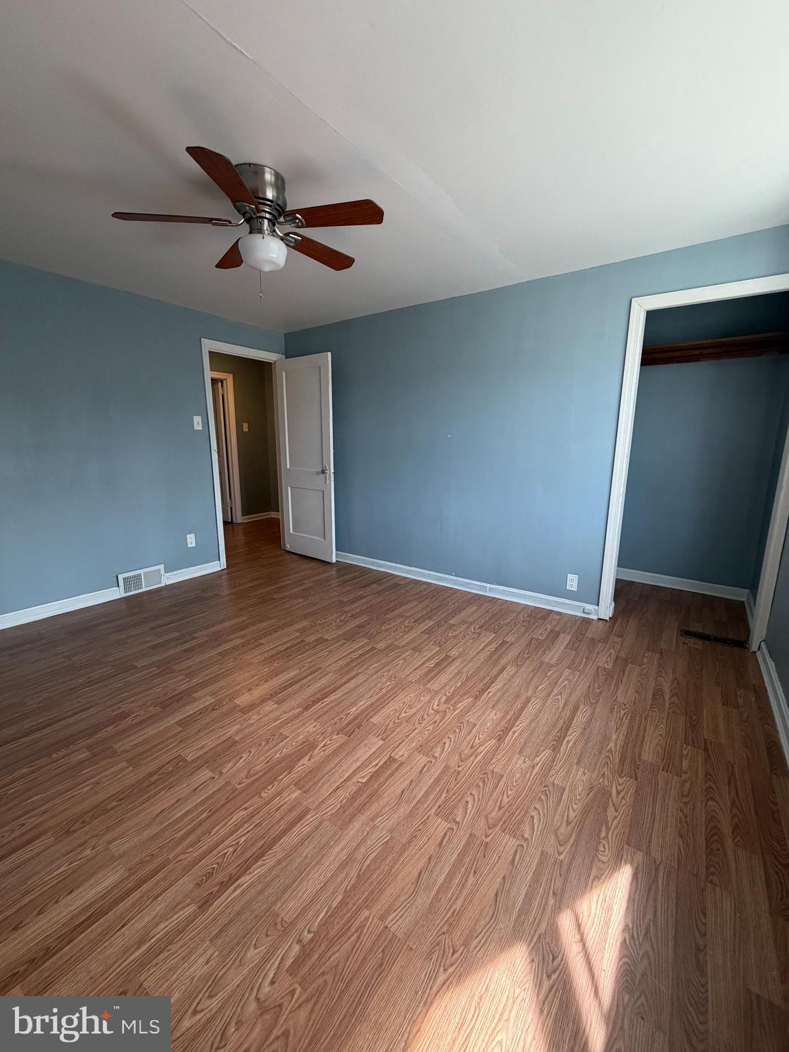 7 West 21st Street Chester, PA 19013 - Photo 9 of 18 a view of an empty room with wooden floor and a ceiling fan