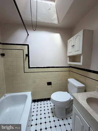 a white toilet sitting next to a bathroom sink