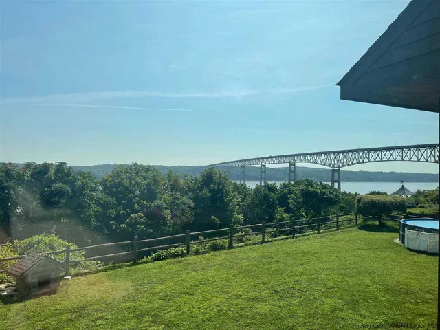 a view of a green field with lawn chairs